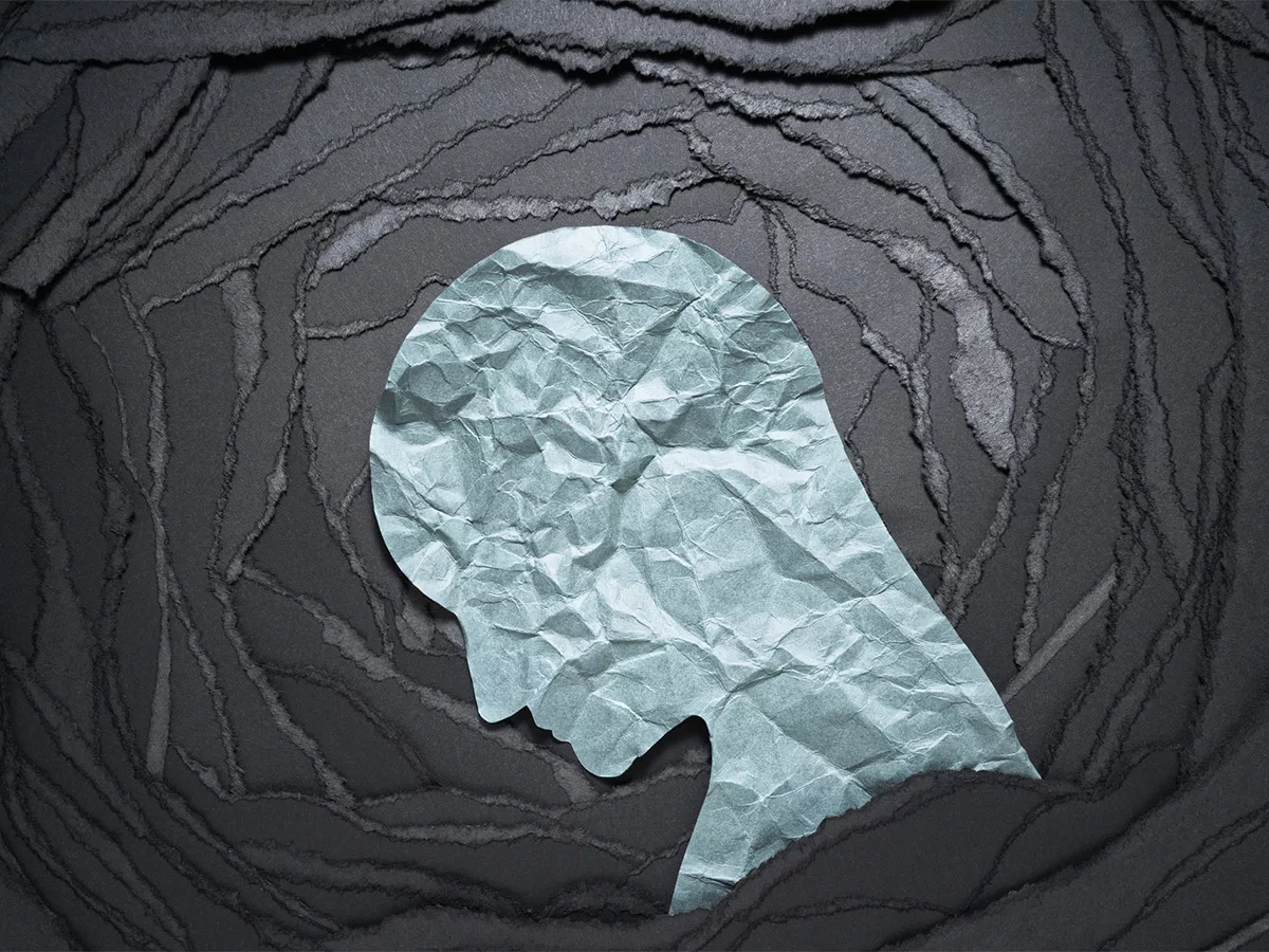 Silhouette made of crumpled paper illustrating depression Silhouette made of crumpled paper illustrating depression