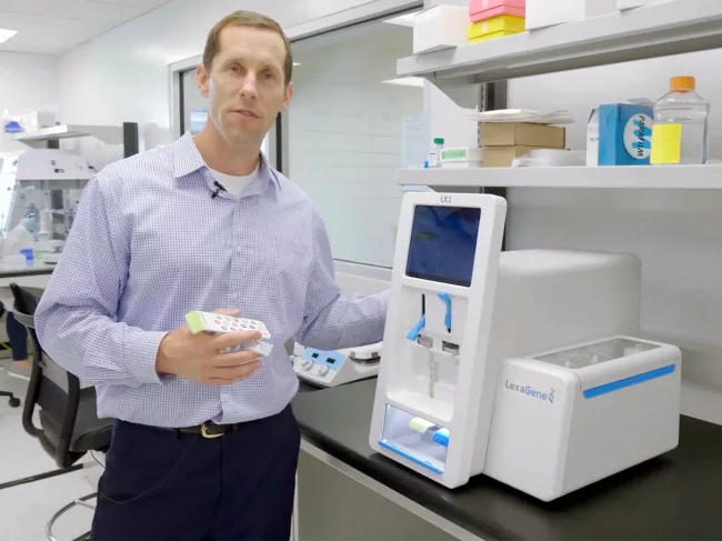 Lexagene CEO in lab with Lx Analyzer 