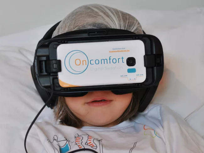 VR headset on child in bed