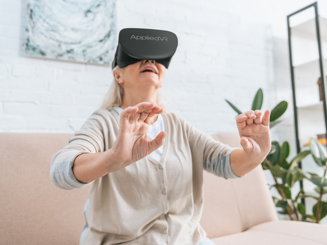 Woman using Appliedvr virtual reality headset at home