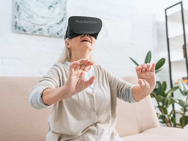 Woman using Appliedvr virtual reality headset at home