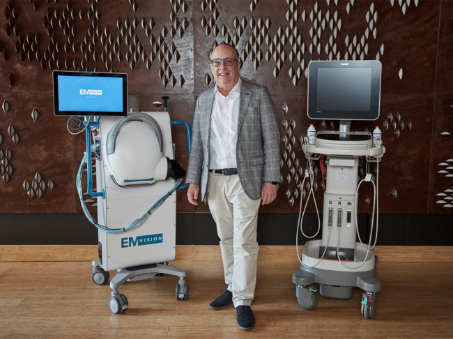 Emvision CEO with device prototype (left) and ultrasound system (right)