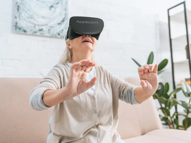 Woman using Appliedvr virtual reality headset at home