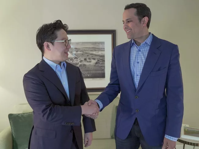 Brandon Suh and Helmy Eltoukhy shaking hands