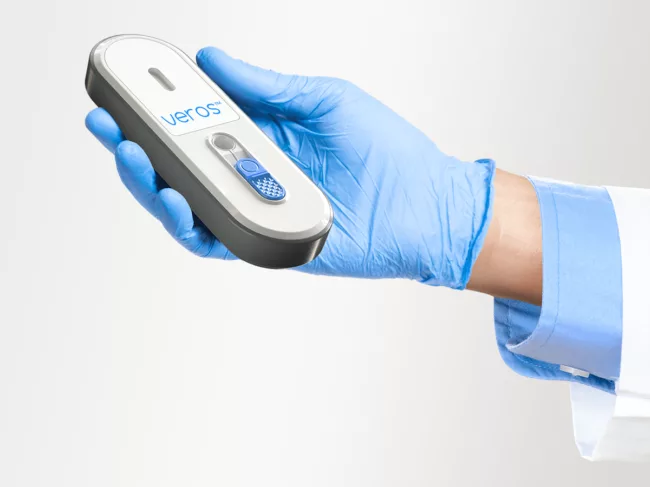 Gloved hand holding Veros platform