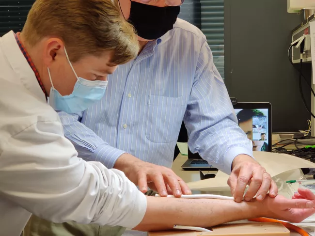 Xeltis team members with a vessel device