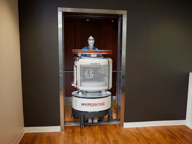 Nurse moving Swoop off hospital elevator