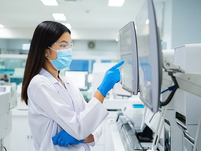 Woman working at computer in laboratory