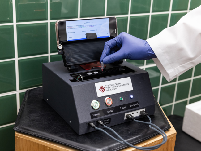Gloved hand puts samples in portable testing device