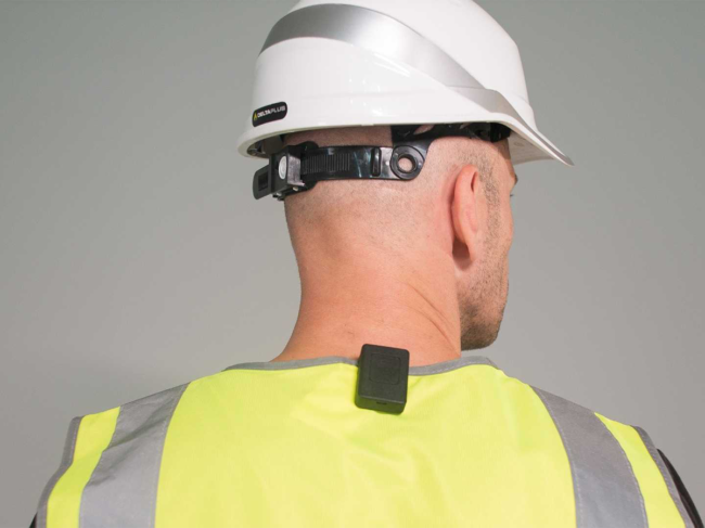 Sotercoach device on back of employee wearing hard hat, safety vest