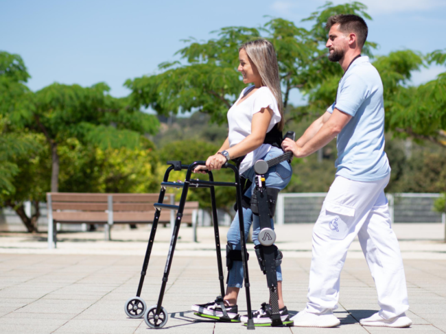 Woman wearing Able exoskeleton walking outside