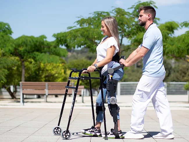 Woman wearing Able exoskeleton walking outside
