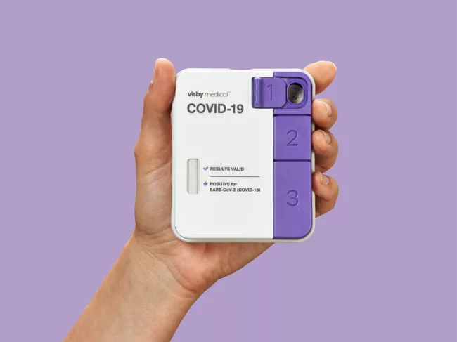 Hand holding Visby's personal PCR device