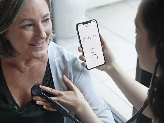 Doctor uses Eko app while listening to patient's heart