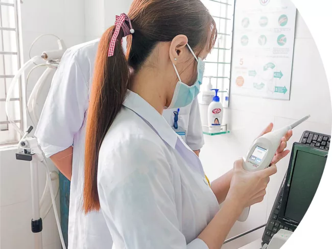Female health professional holding Truscreen device