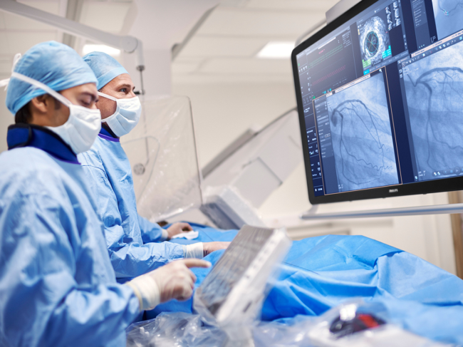 Surgeons using  image guided therapy system