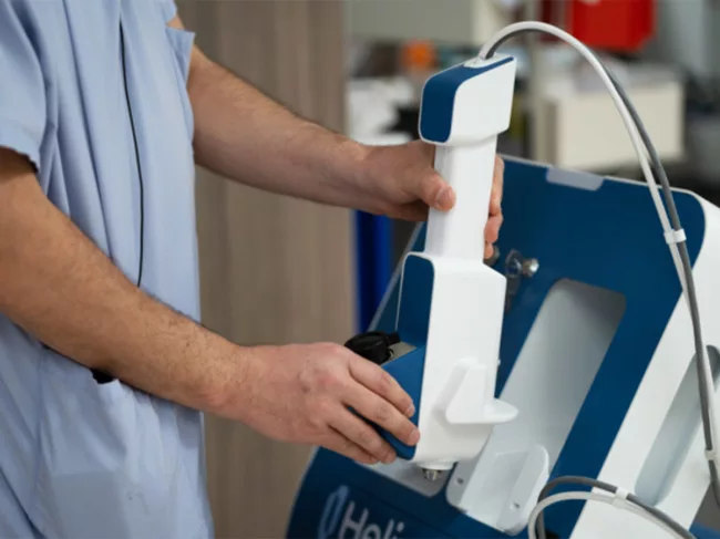 Close up of surgeon holding Rx device