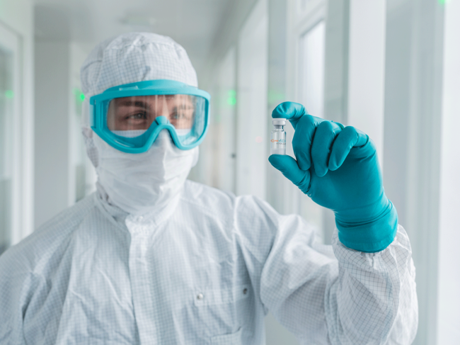 Curevac scientist holding vial