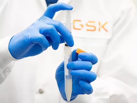 GSK scientist holding lab syringe