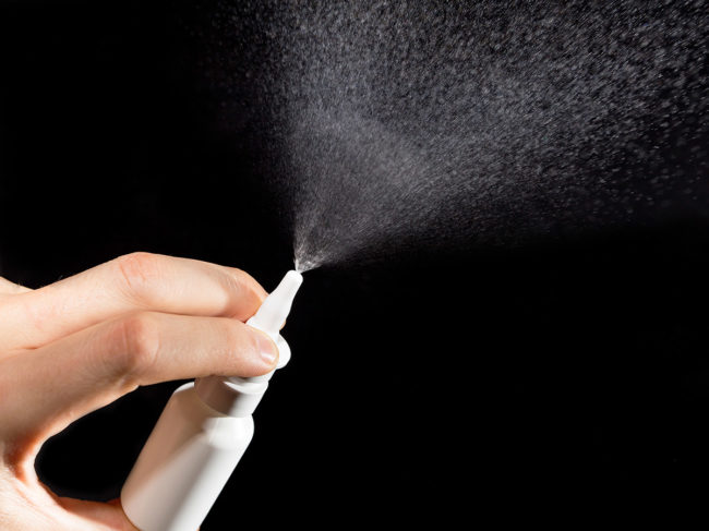 Close-up of nasal drug spraying