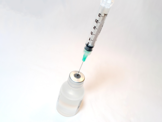 Needle syringe with a vaccine vial.
