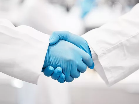 Research collaboration deal handshake gloves