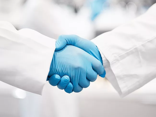 Photo of researchers shaking hands