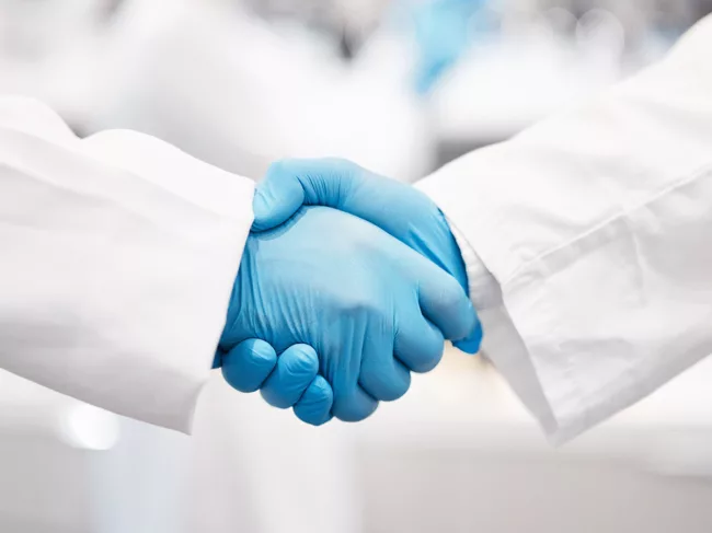 Photo of researchers shaking hands