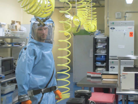 Man wearing protective suit in laboratory