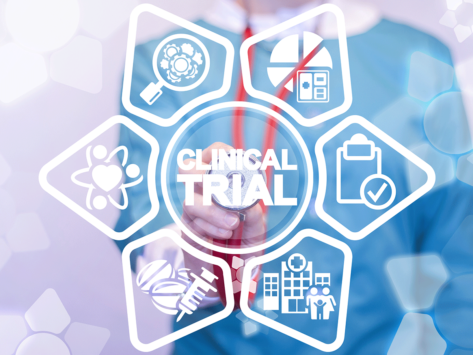 Health professional pointing stethoscope at Clinical Trial words, icons