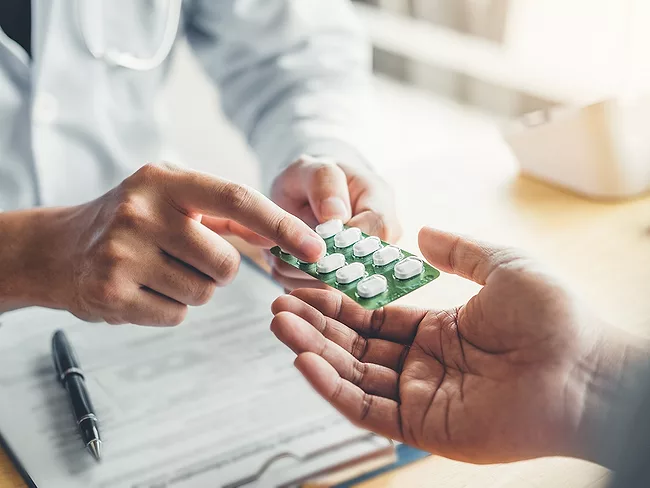 Doctor giving medicine to patient