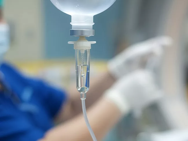 Health care worker with IV drip