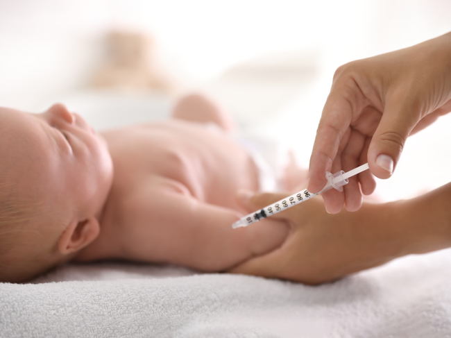 Infant receiving vaccine