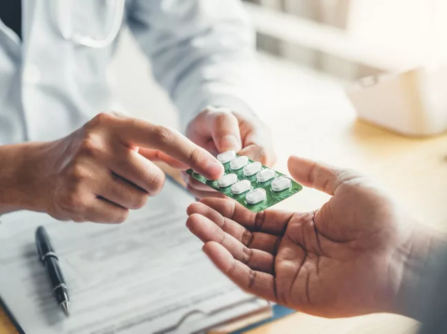 Doctor giving medicine to patient