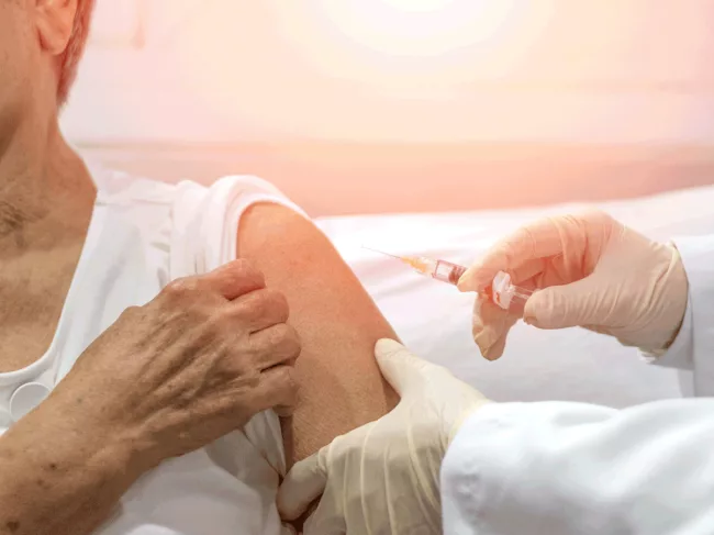 Elderly person receiving shot