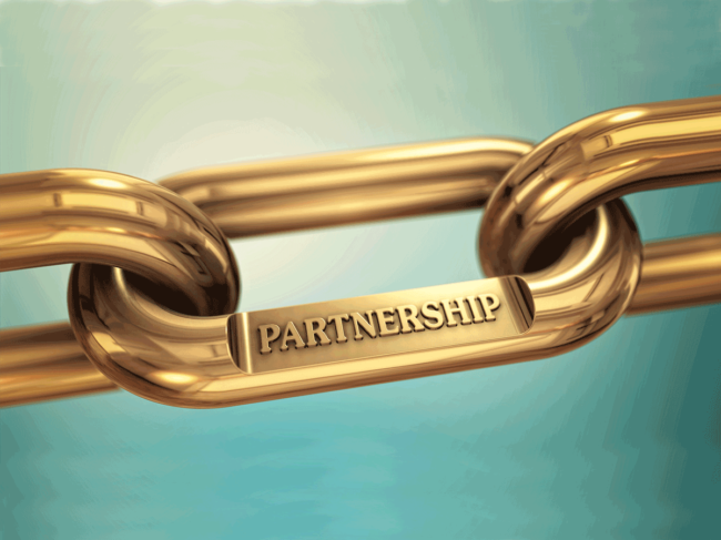 Gold chain link engraved with "partnership"