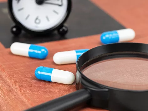 Magnifying glass clock and capsules