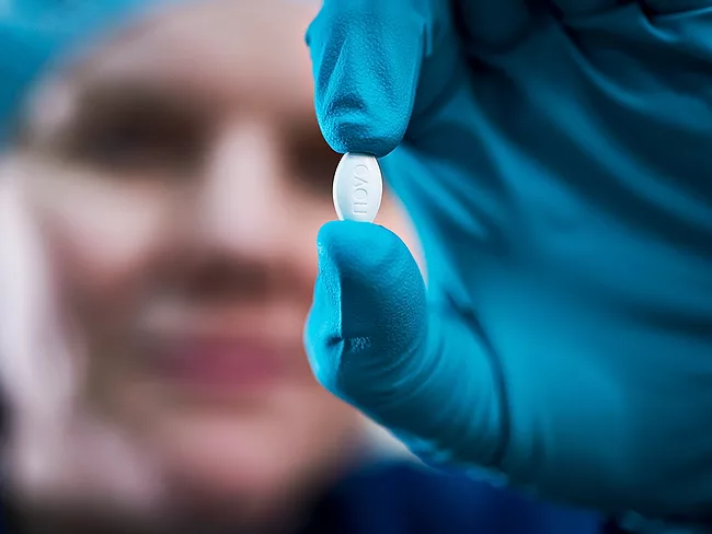Scientist holding semaglutide pill