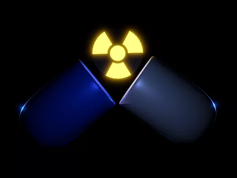 Open blue capsule with yellow radioactive symbol