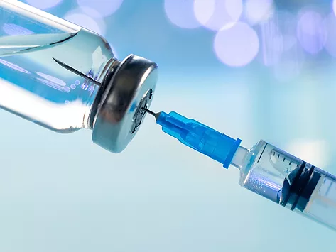 Vial and syringe with blue hues