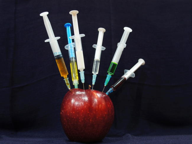 Syringes in an apple