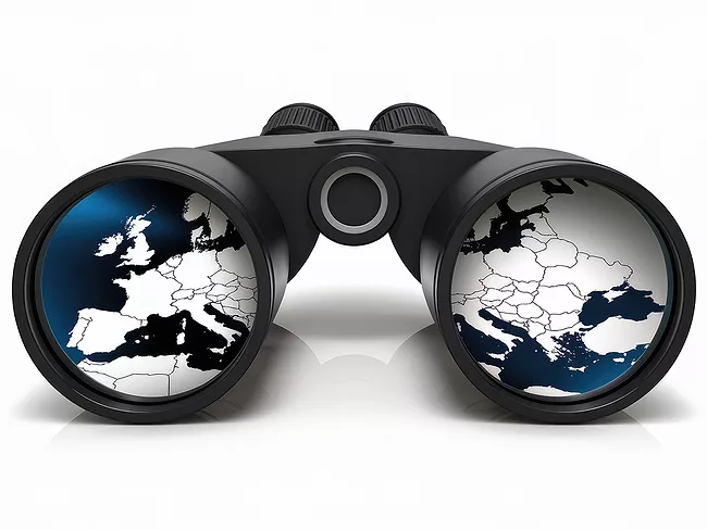 Binoculars focused on a map of Europe