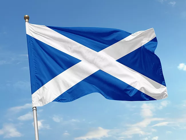 Flag of Scotland against blue sky