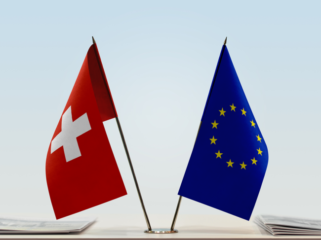 Swiss, EU flags on a table