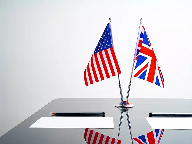 Flags of US and UK on negotiation table
