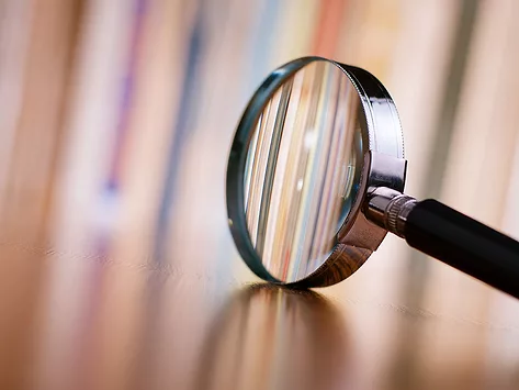 Magnifying glass on wooden table