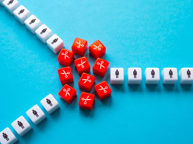 Three lines of white dice with people icons, red dice with scissors icons