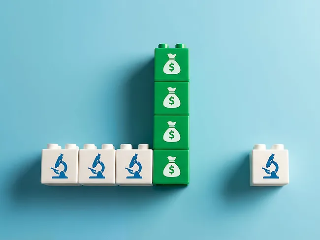 Blocks displaying microscopes and money bags