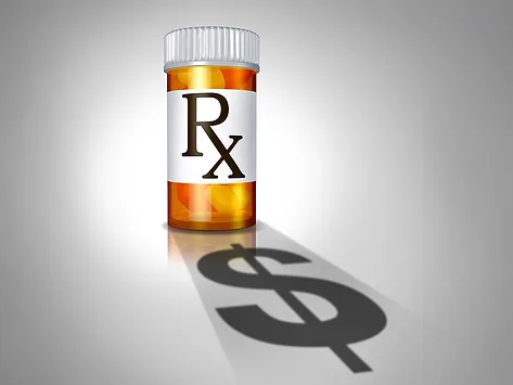 Prescription bottle with dollar sign shadow