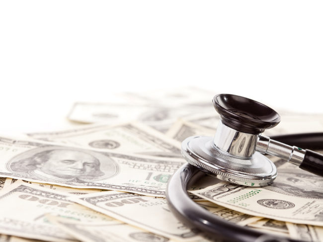 US currency and stethoscope